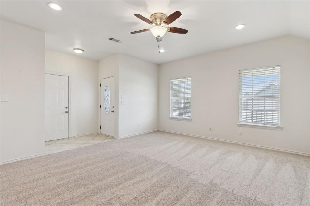 233 Firefly Drive Springtown, TX 76082 - Photo 3 of 16 Living room with front door and garage door present