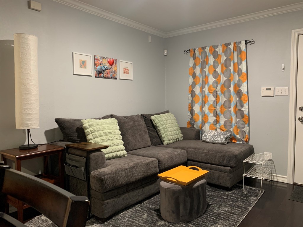407 East 45th Street, Unit 116 Austin, TX 78751 - Photo 1 of 19 Living area featuring crown molding and dark wood-style flooring