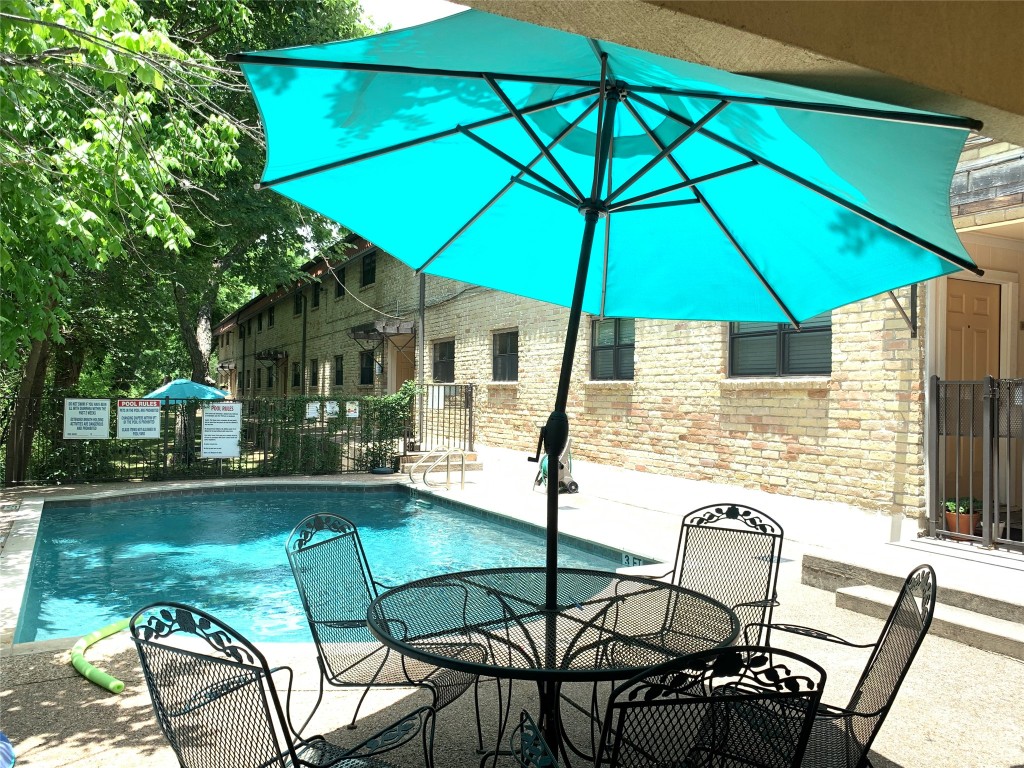 407 East 45th Street, Unit 116 Austin, TX 78751 - Photo 12 of 19 Community pool with a patio and outdoor dining area