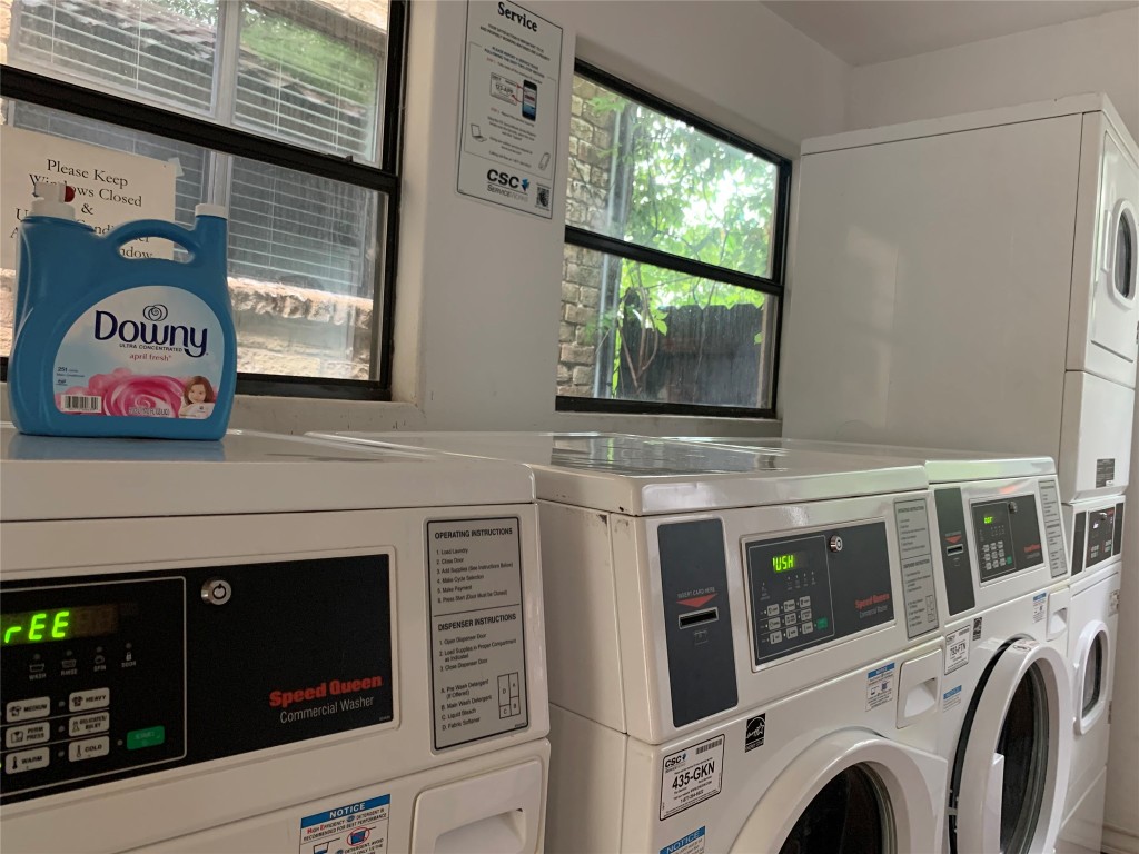 407 East 45th Street, Unit 116 Austin, TX 78751 - Photo 13 of 19 Shared laundry room with plenty of natural light, stacked washer and clothes dryer, and washing machine and clothes dryer