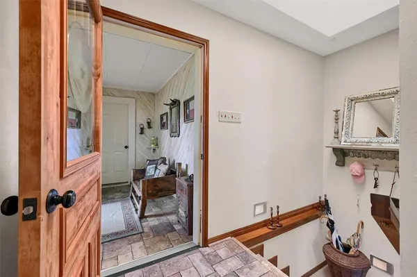 a view of a hallway with workspace and living room