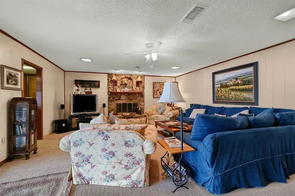 a living room with furniture a rug and a flat screen tv