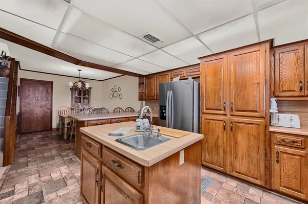 a kitchen with stainless steel appliances granite countertop a sink refrigerator and cabinets