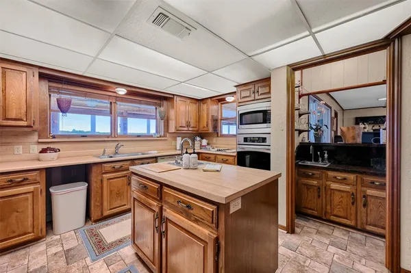 a kitchen with stainless steel appliances granite countertop a stove sink and cabinets