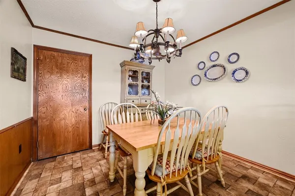 a view of a dining room with furniture and a chandelier