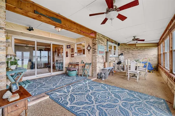a living room with furniture a rug and white walls