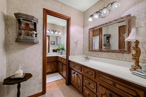 a bathroom with a sink a toilet and a mirror