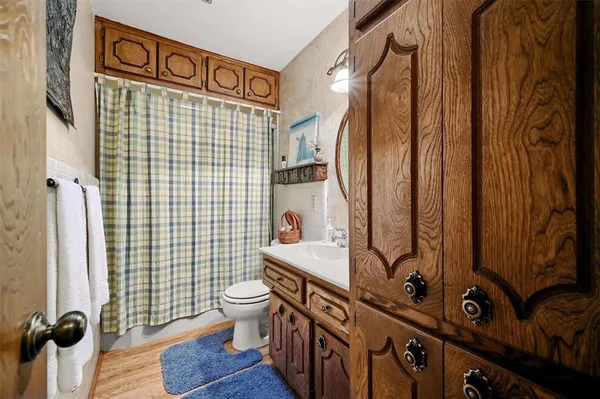 a bedroom with a bed and a flat tv screen on the dresser