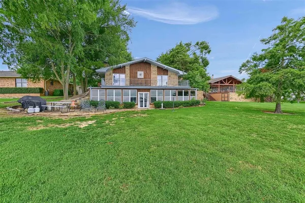 a view of a house with a yard and sitting area