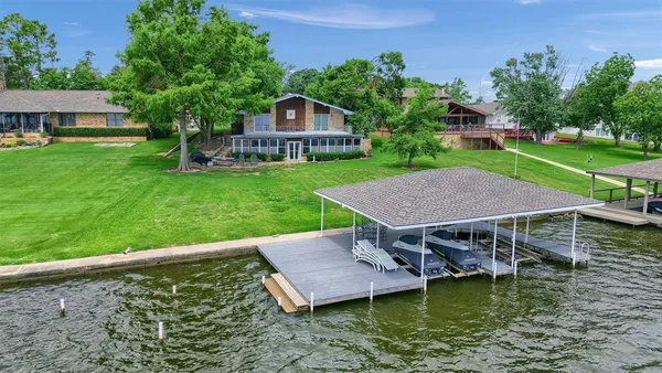 an aerial view of a house with swimming pool garden and patio