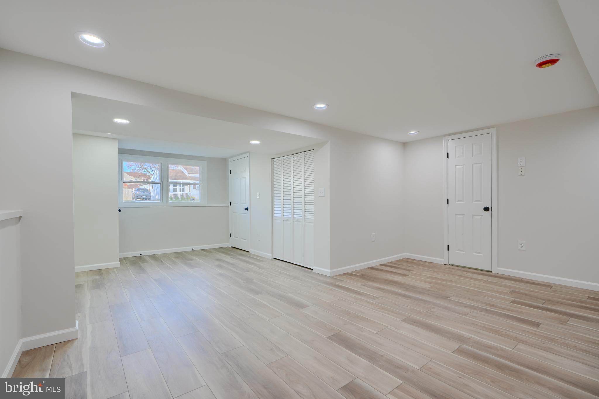 1836 Colmar Road Baltimore, MD 21207 - Photo 33 of 47 a view of an empty room with wooden floor and a window