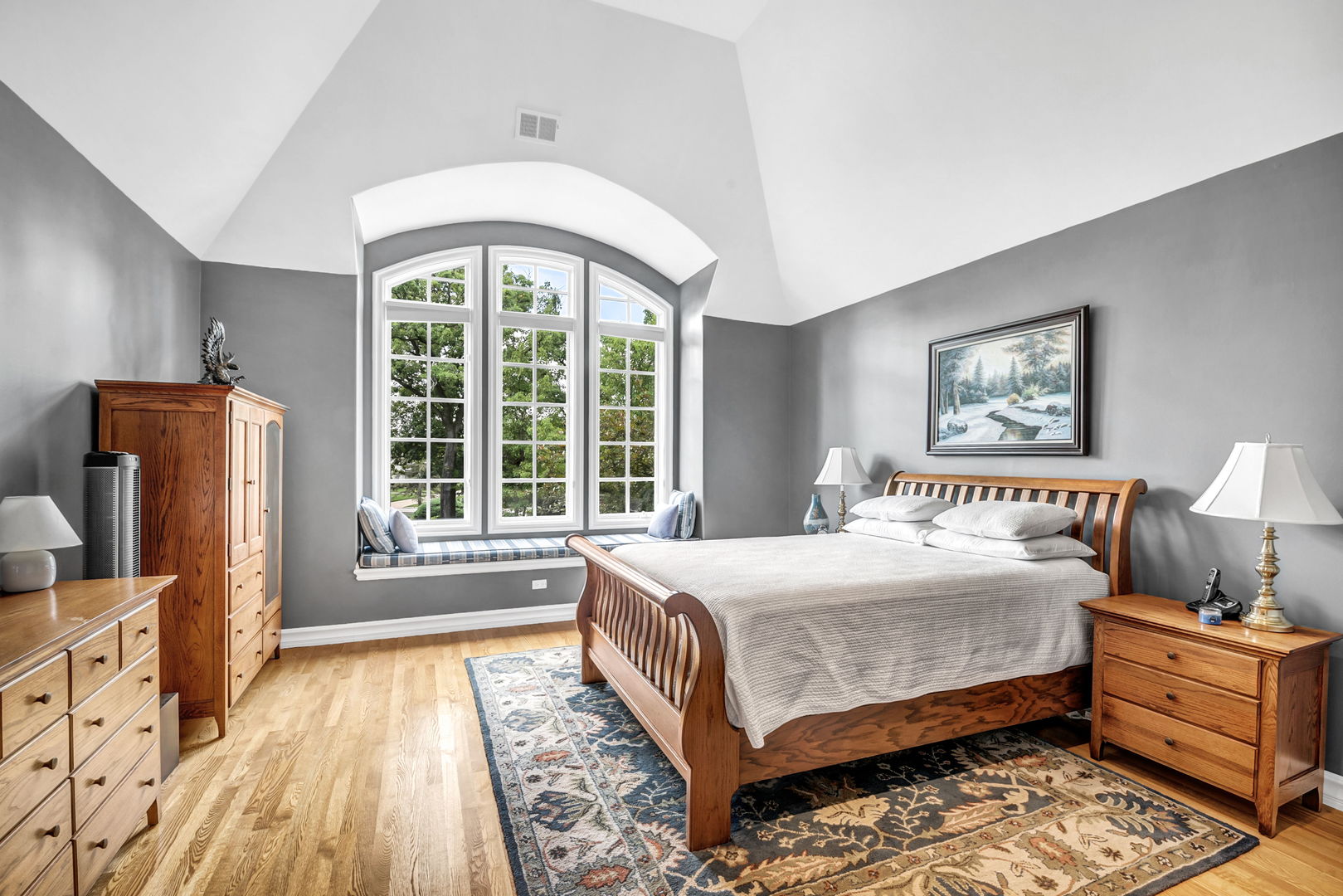 210 Indian Trail Road Oak Brook, IL 60523 - Photo 20 of 48 a bedroom with a large bed a flat tv screen and dresser