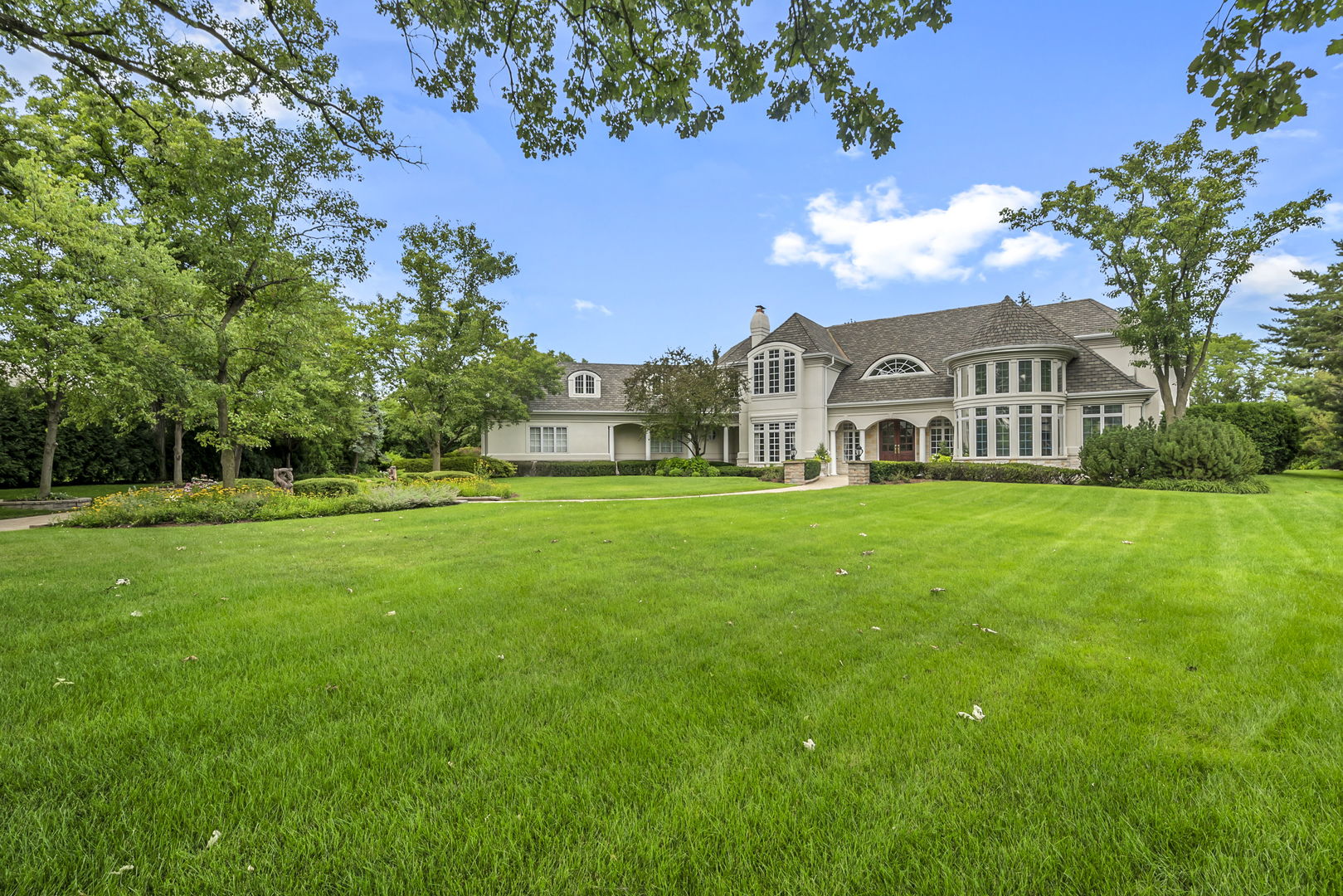 210 Indian Trail Road Oak Brook, IL 60523 - Photo 2 of 48 a view of a house with a big yard and large trees