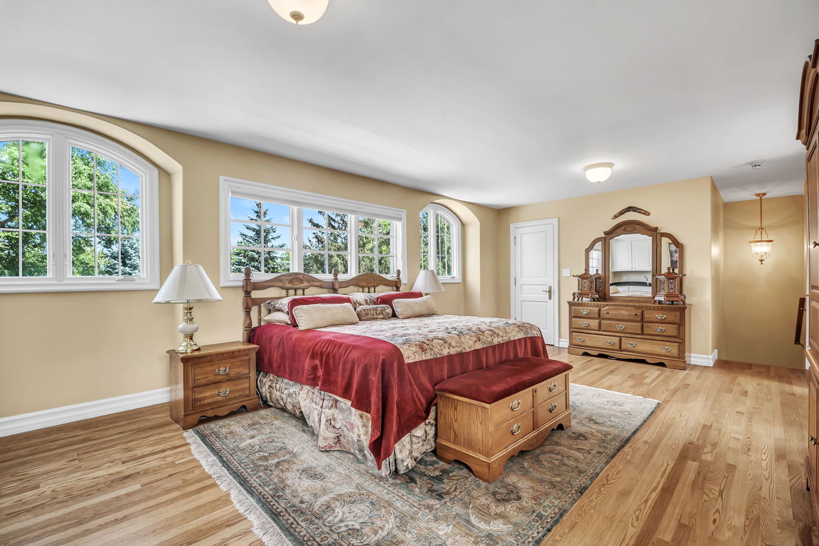 210 Indian Trail Road Oak Brook, IL 60523 - Photo 25 of 48 a spacious bedroom with a bed a window and wooden floor