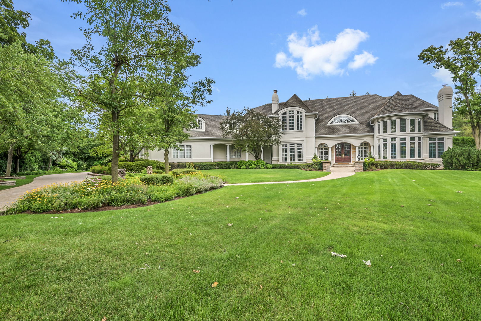 210 Indian Trail Road Oak Brook, IL 60523 - Photo 3 of 48 a front view of a house with a garden