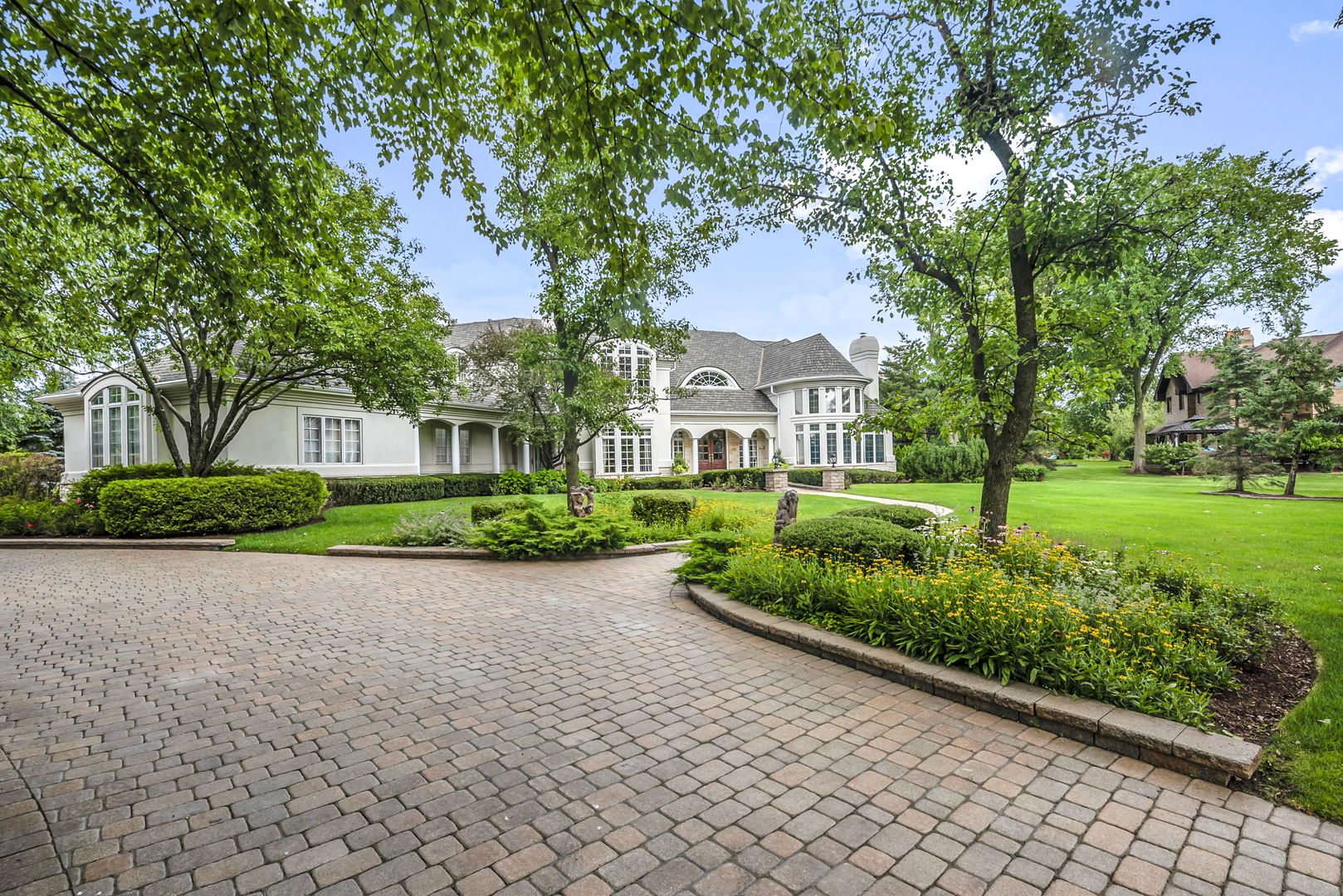 210 Indian Trail Road Oak Brook, IL 60523 - Photo 4 of 48 a front view of a house with a yard and potted plants