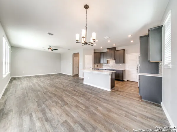 a kitchen with a sink appliances and cabinets