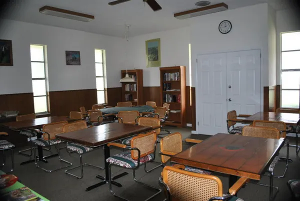a room with pool table and wooden floor