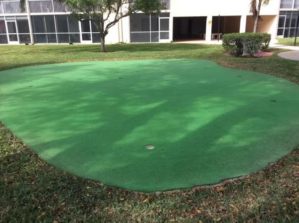 a view of a balcony with a floor to ceiling window and wooden fence