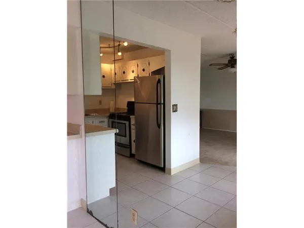 a kitchen with a refrigerator and a sink