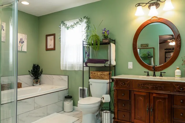a living room with furniture a flat screen tv and a window