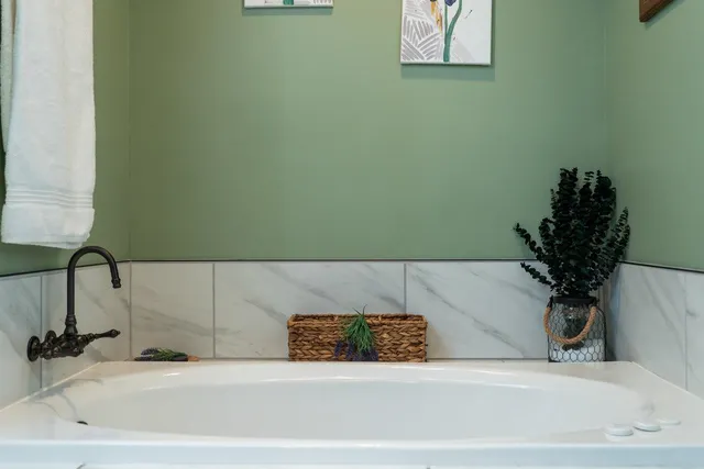 a bedroom with a bed mirror and window