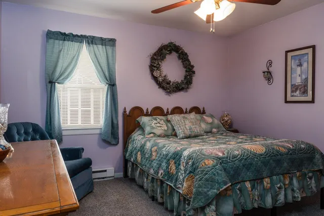 a bedroom with furniture and a lamp