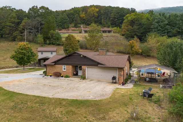 a front view of a house with swimming pool and porch