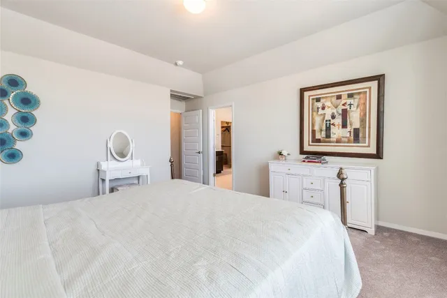 a bedroom with a bed lamp and window