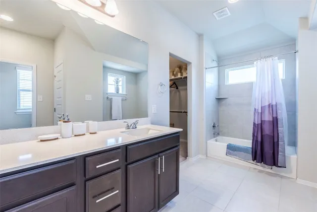 a bedroom with a large bed and a cabinets