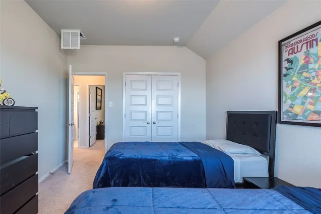 a bedroom with a bed and window