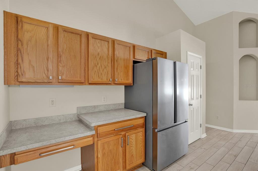 4400 Dior Road Spring Hill, FL 34609 - Photo 15 of 37 a kitchen with stainless steel appliances granite countertop a refrigerator a stove a sink and dishwasher