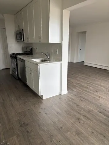 a view of a kitchen with electric appliances