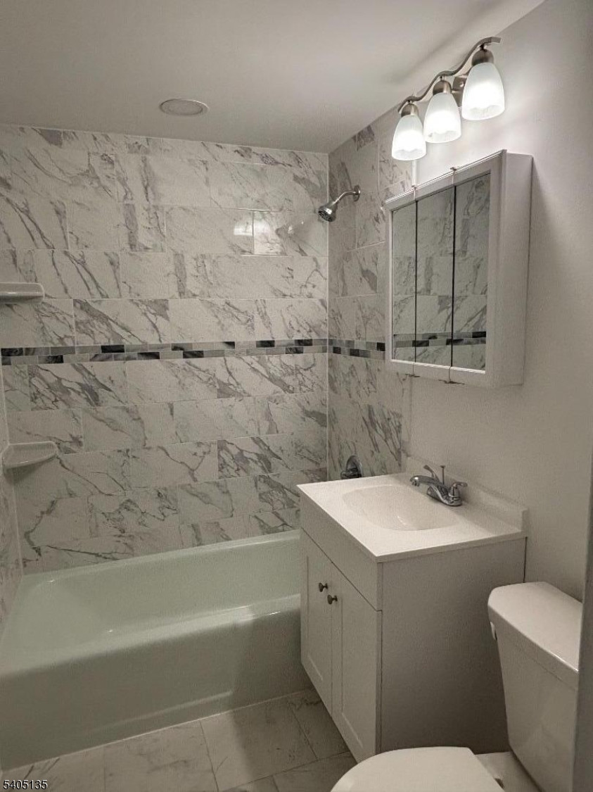 1 River Road, Unit C Nutley, NJ 07110 - Photo 13 of 14 a bathroom with a sink toilet vanity and shower