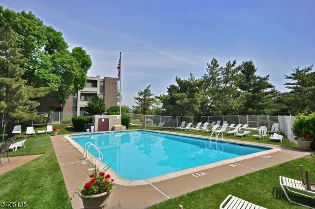 a view of a swimming pool with outdoor seating and plants