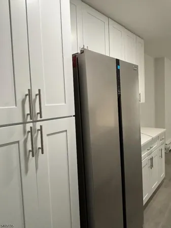 a white refrigerator freezer sitting inside of a kitchen