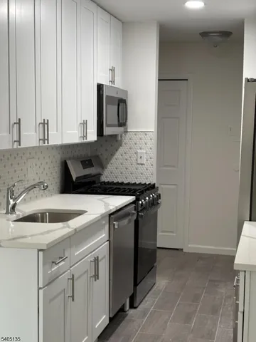 a kitchen with a sink and cabinets