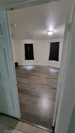 a view of room with wooden floor