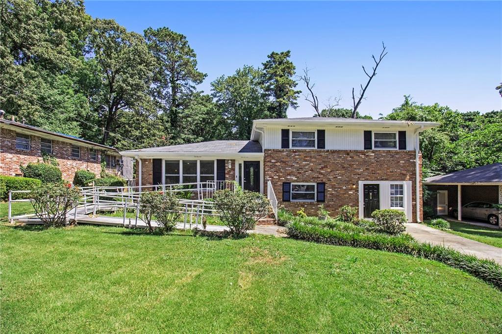 a front view of house with yard and green space