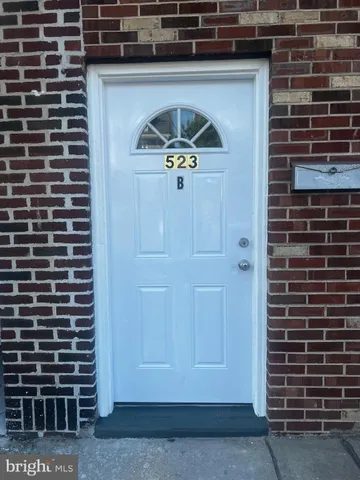 a kitchen with stainless steel appliances a stove a microwave and white cabinets