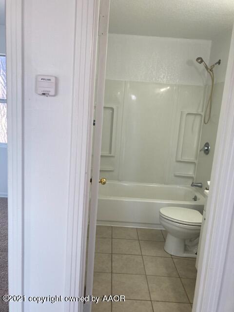 4608 Preston Street Amarillo, TX 79110 - Photo 3 of 9 a bathroom with a toilet a sink and bathtub