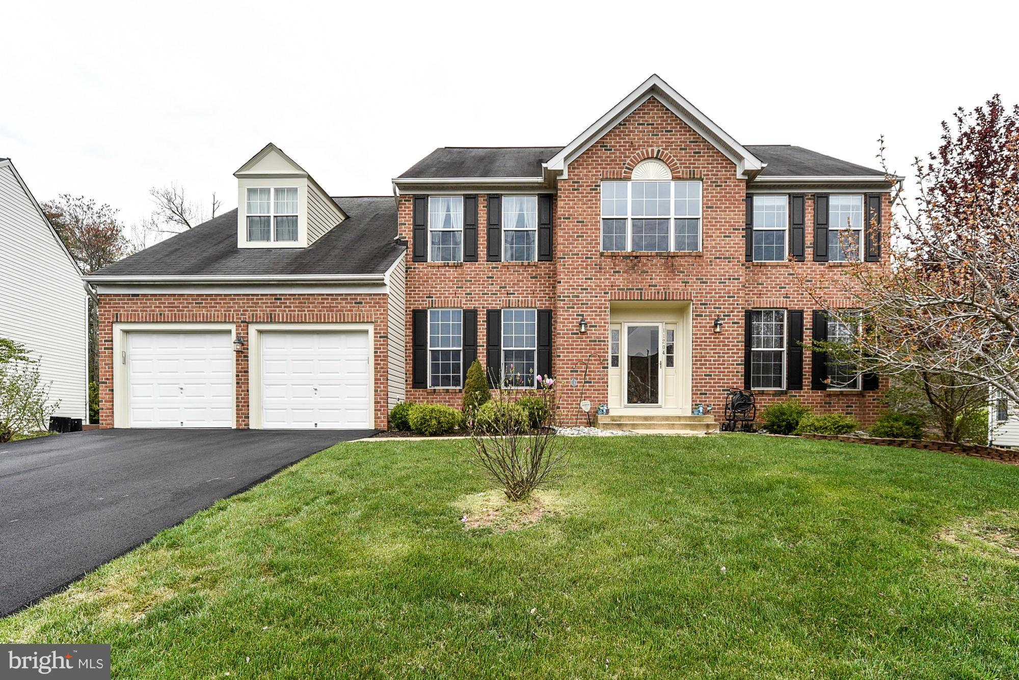 11204 Snowden Pond Road Laurel, MD 20708 - Photo 1 of 30 a front view of a house with a yard and garage