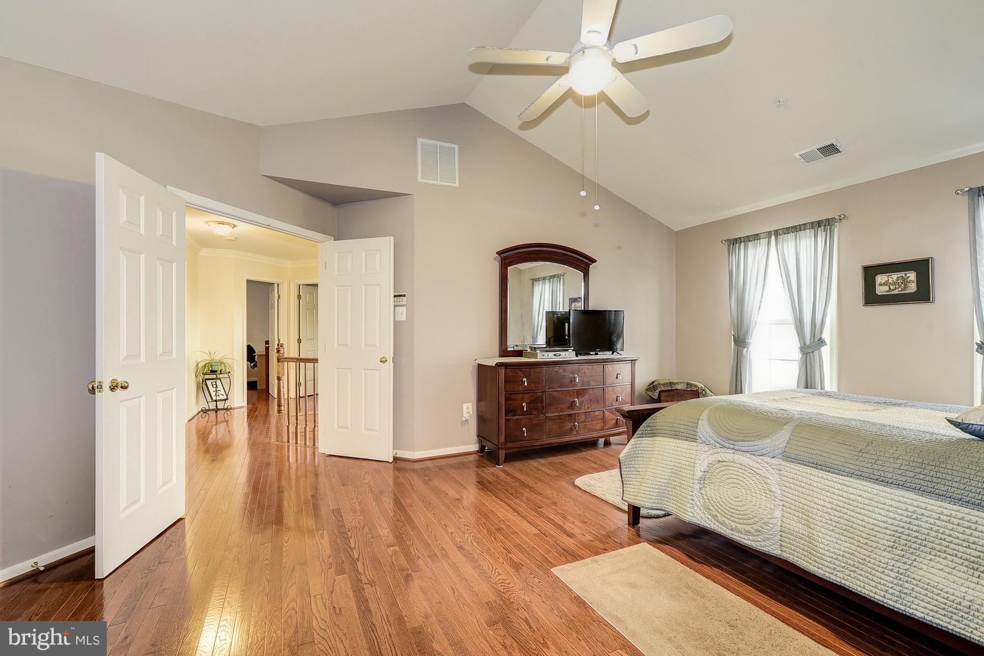 11204 Snowden Pond Road Laurel, MD 20708 - Photo 16 of 30 a bedroom with furniture and wooden floor