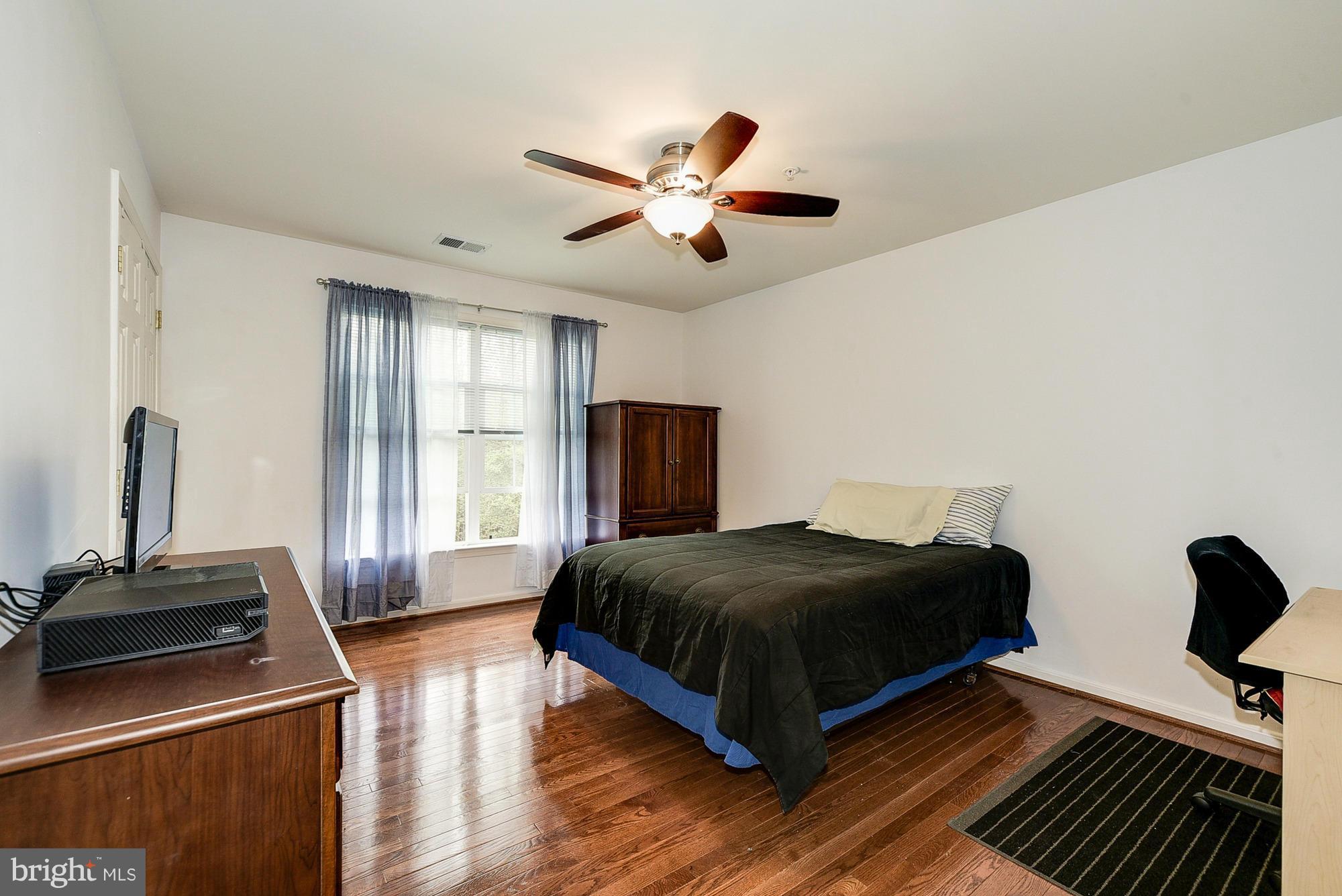 11204 Snowden Pond Road Laurel, MD 20708 - Photo 23 of 30 a bedroom with a bed and wooden floor