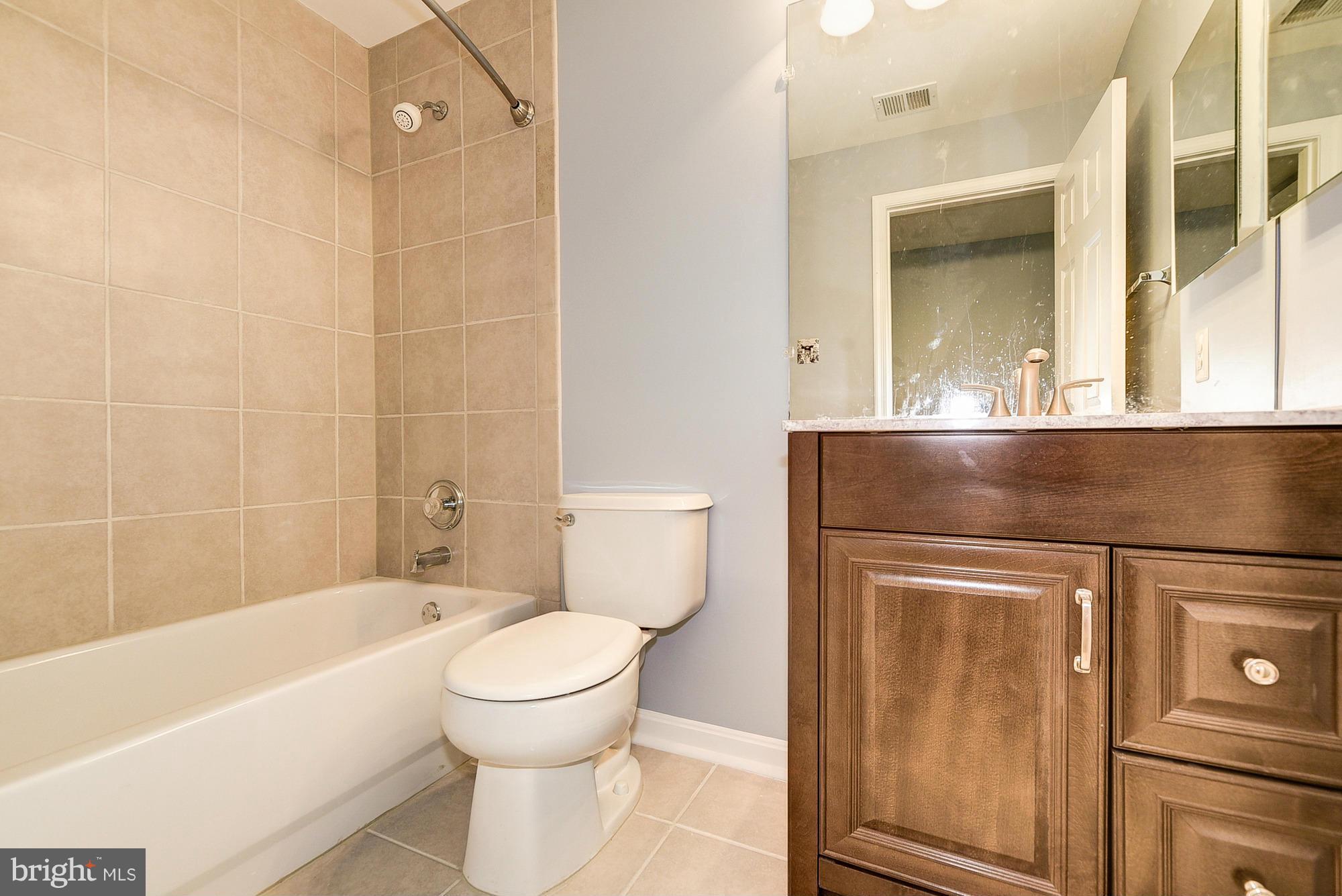 11204 Snowden Pond Road Laurel, MD 20708 - Photo 28 of 30 a bathroom with a toilet and a bathtub