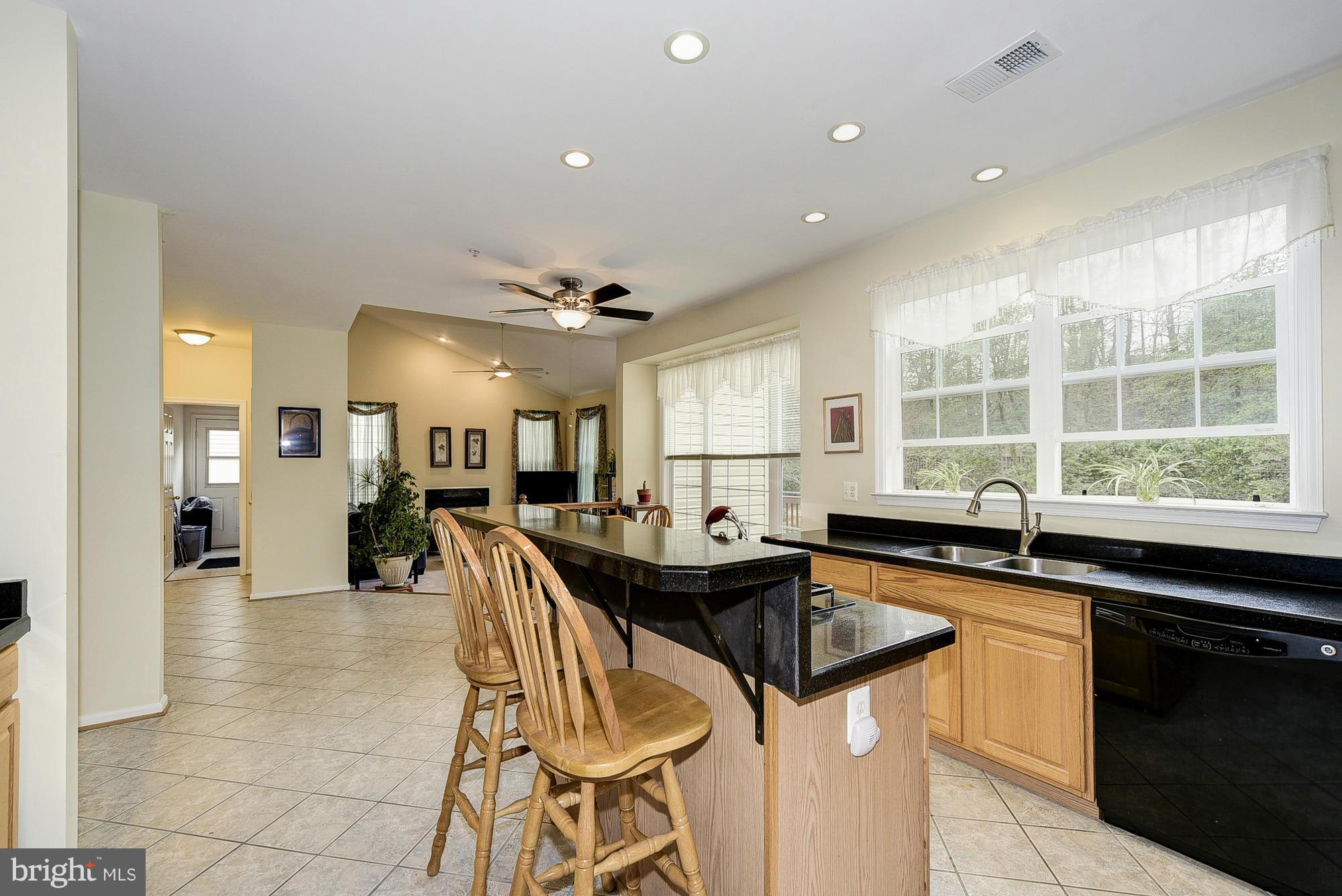 11204 Snowden Pond Road Laurel, MD 20708 - Photo 9 of 30 a kitchen with stainless steel appliances granite countertop a sink and a stove