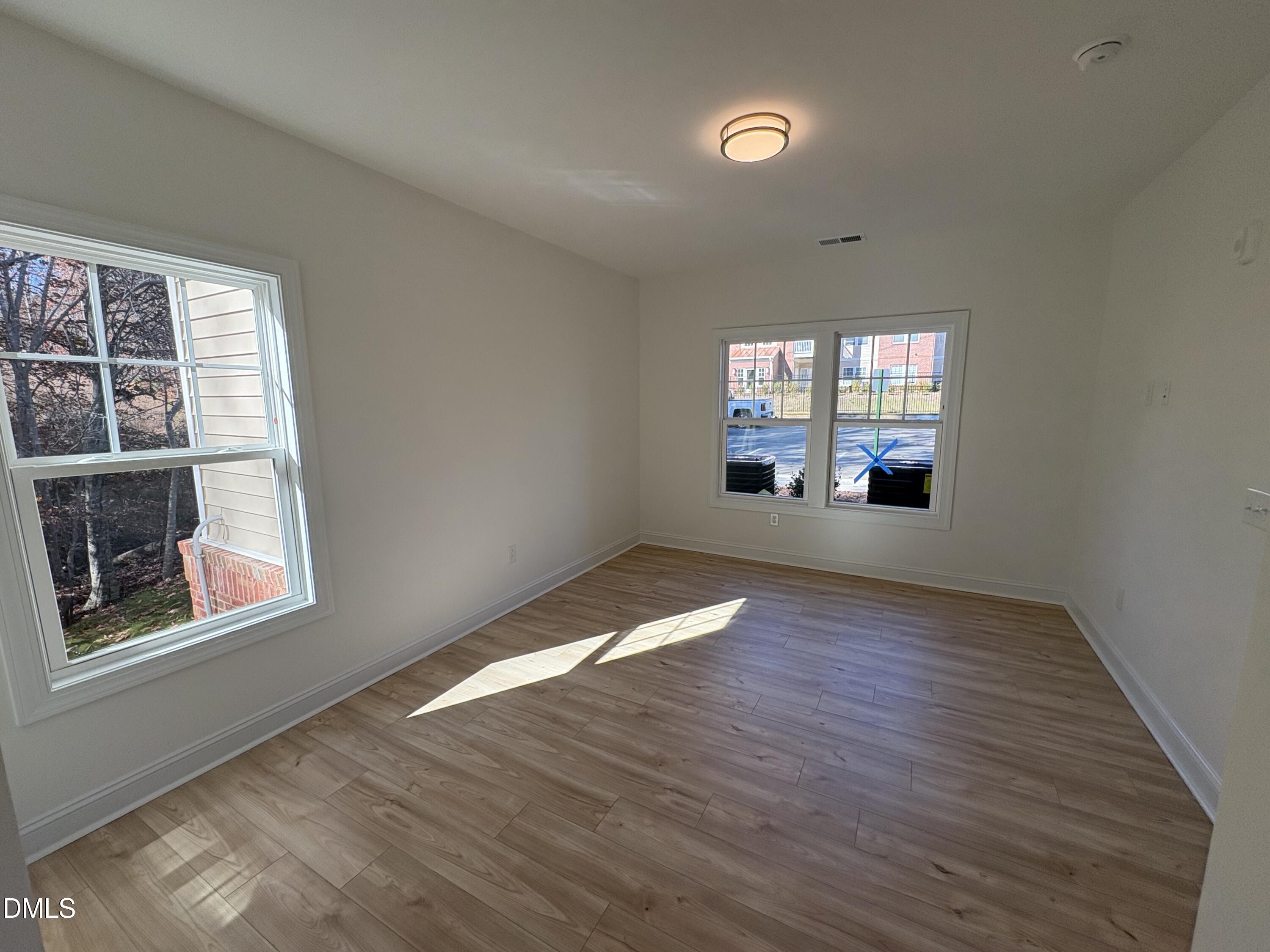 618 Weather Ridge Lane, Unit 28 Cary, NC 27513 - Photo 10 of 27 wooden floor in an empty room with a window