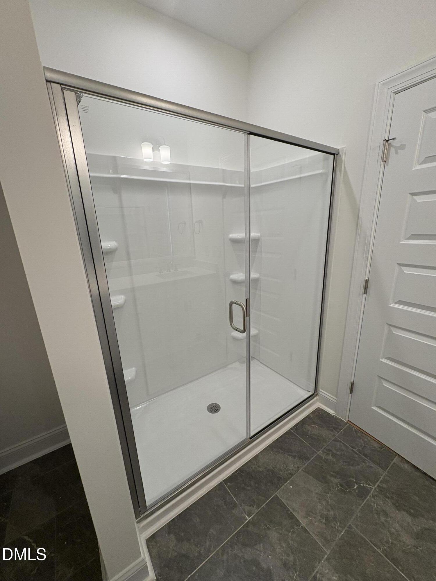 618 Weather Ridge Lane, Unit 28 Cary, NC 27513 - Photo 14 of 27 a bathroom with a glass door shower