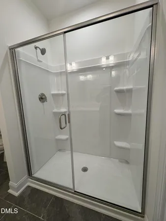 a bathroom with a glass door shower