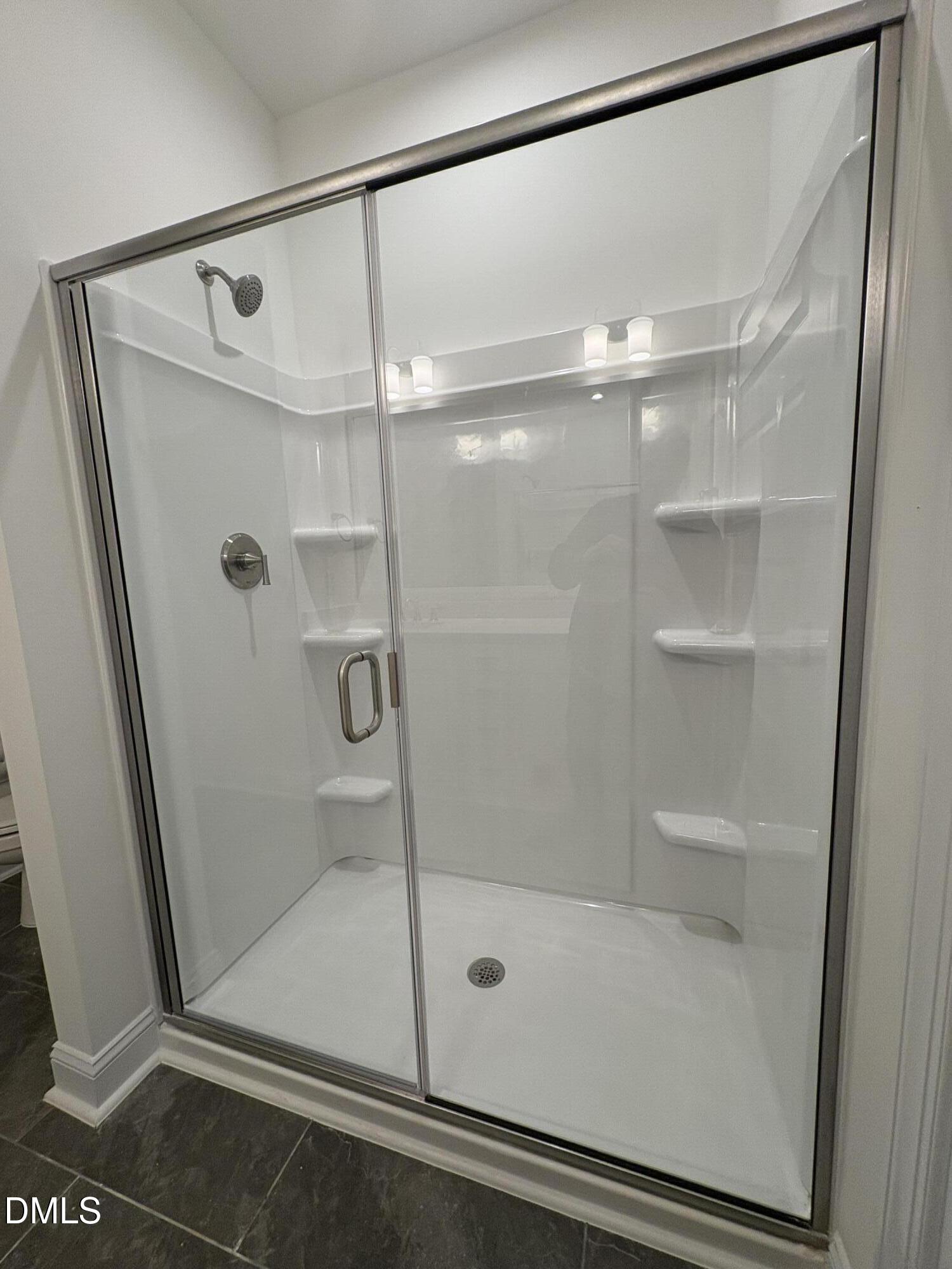 618 Weather Ridge Lane, Unit 28 Cary, NC 27513 - Photo 15 of 27 a bathroom with a glass shower door
